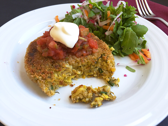 Vegetable burger patty topped with tomato salsa and cultured sour cream